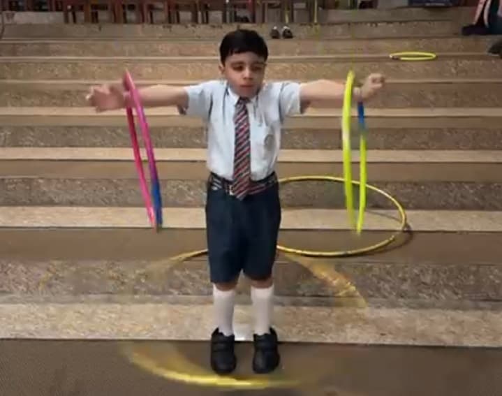 Longest Spinning Hula Hoops around both Arms and Knees
